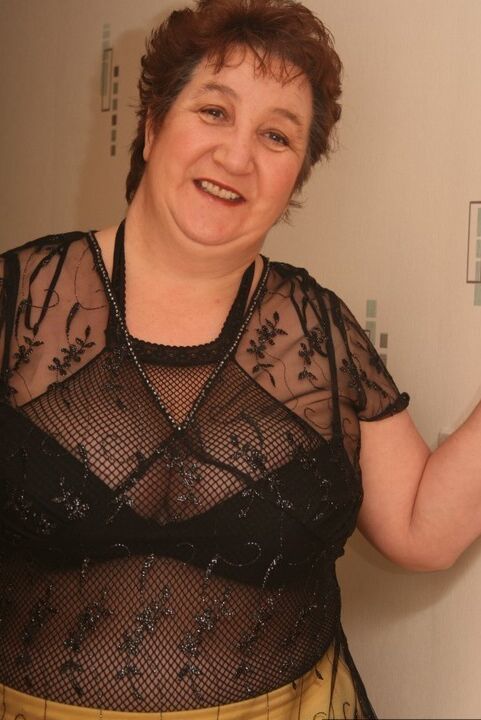 20P Older redhead Kinky Carol displays her plump figure in a crotchless stocking
