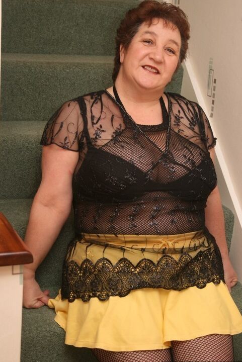 20P Older redhead Kinky Carol displays her plump figure in a crotchless stocking