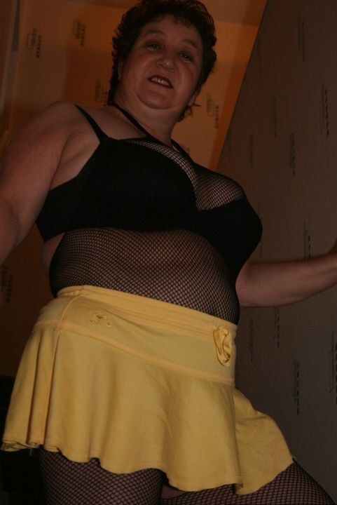 20P Older redhead Kinky Carol displays her plump figure in a crotchless stocking