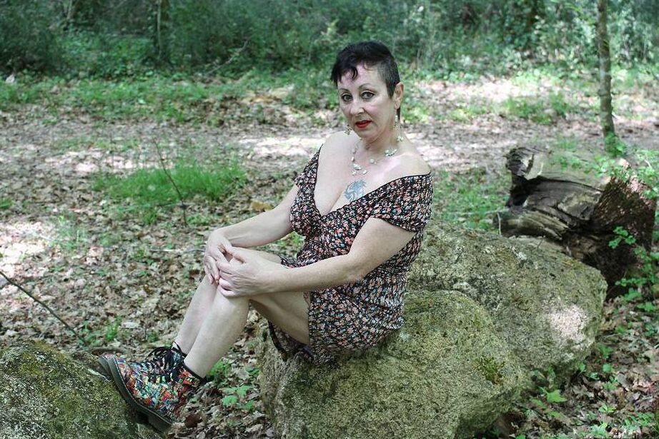 20P Older woman Mary Bitch picks a bunch of flowers while getting naked in a field