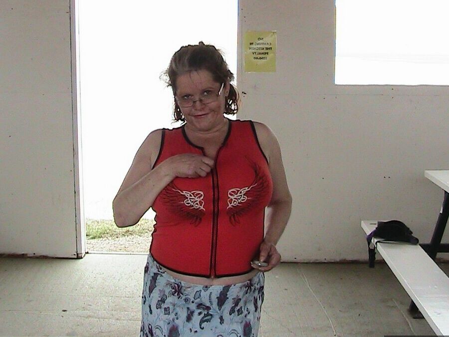 20P Older redhead Misha MILF displays her large tits by a lake before dildo riding