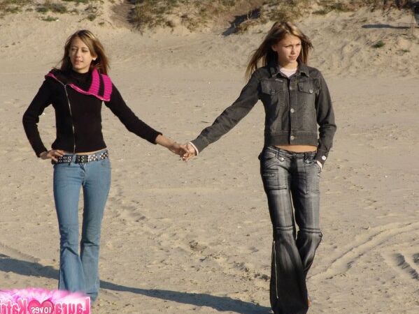 15P Young lesbians Lauraa and Katrina exposes their small tits while at the beach