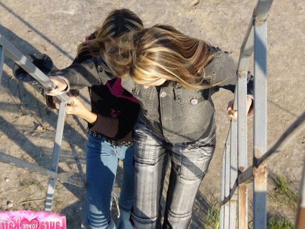 15P Young lesbians Lauraa and Katrina exposes their small tits while at the beach