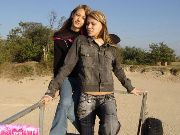 15P Young lesbians Lauraa and Katrina exposes their small tits while at the beach