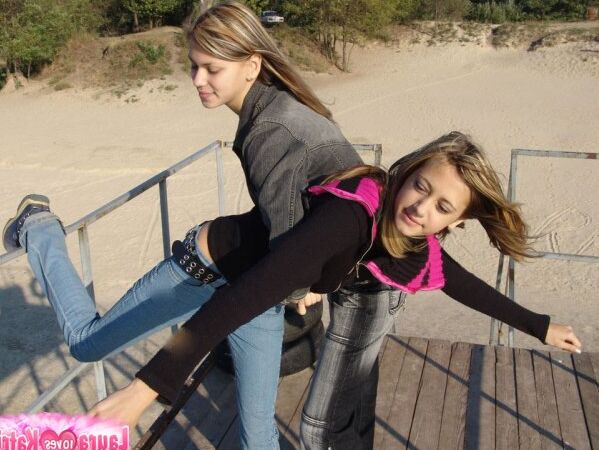15P Young lesbians Lauraa and Katrina exposes their small tits while at the beach