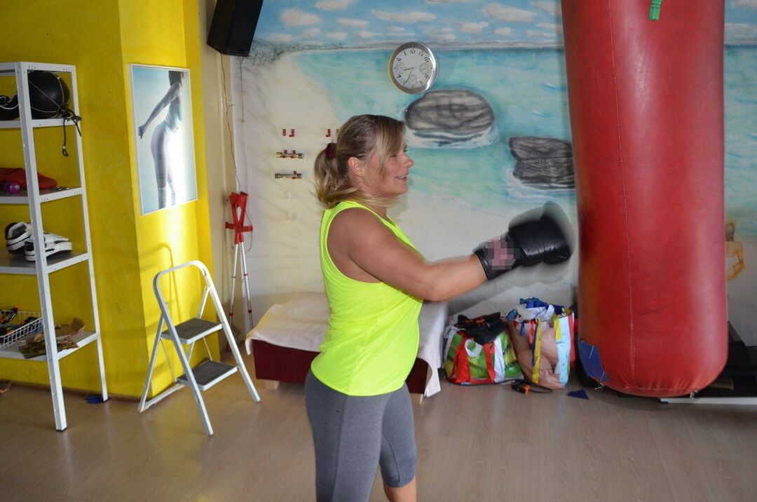 16P Middle-aged blonde Sweet Susi gets naked after working out with a punching bag