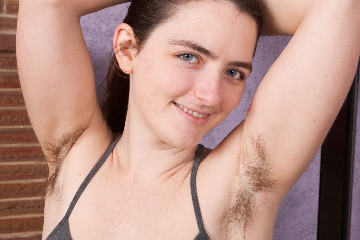 16P Amateur with big natural tits reveals unshaven pits and bush while disrobing