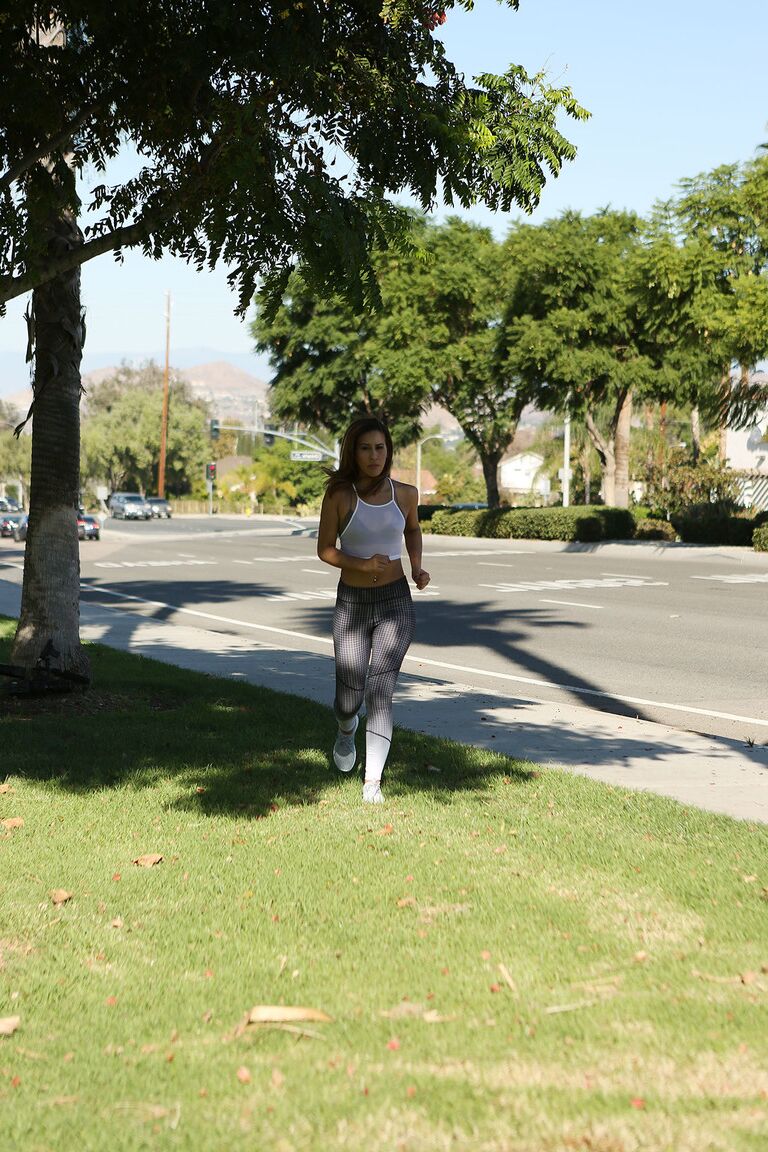 17P Exercising brunette Demi Lopez pause to masturbate clothed pussy on the lawn