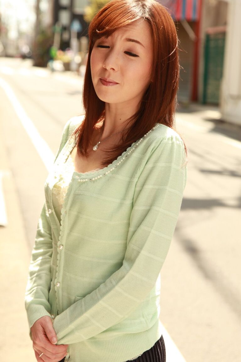 15P Japanese redhead Chika Sasaki models in a sweater and skirt in the road