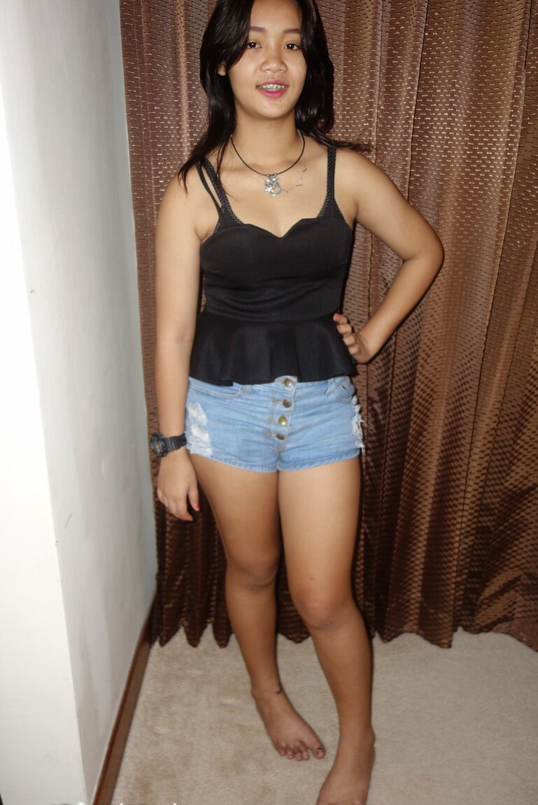17P Cute Thai girl in braces and flip flops lounges about in her shorts and blouse