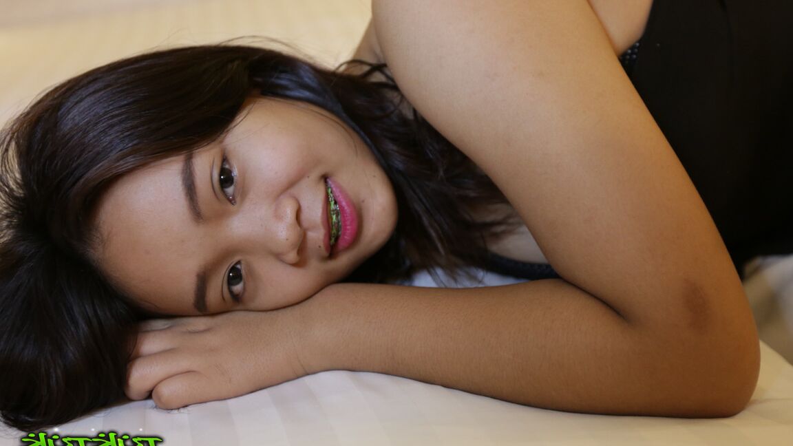 17P Cute Thai girl in braces and flip flops lounges about in her shorts and blouse