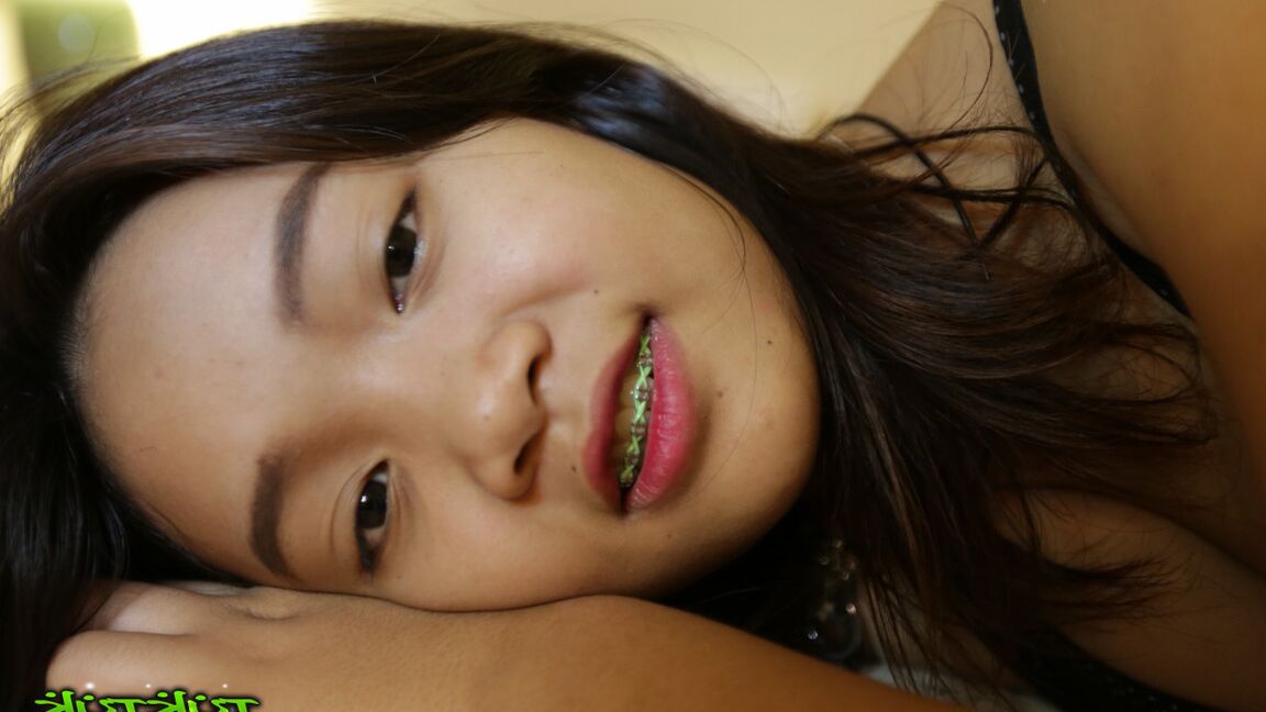 17P Cute Thai girl in braces and flip flops lounges about in her shorts and blouse
