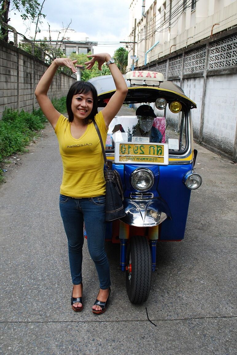 17P Female Tuk Tuk driver and a Farang ham it up for the camera in a back alley