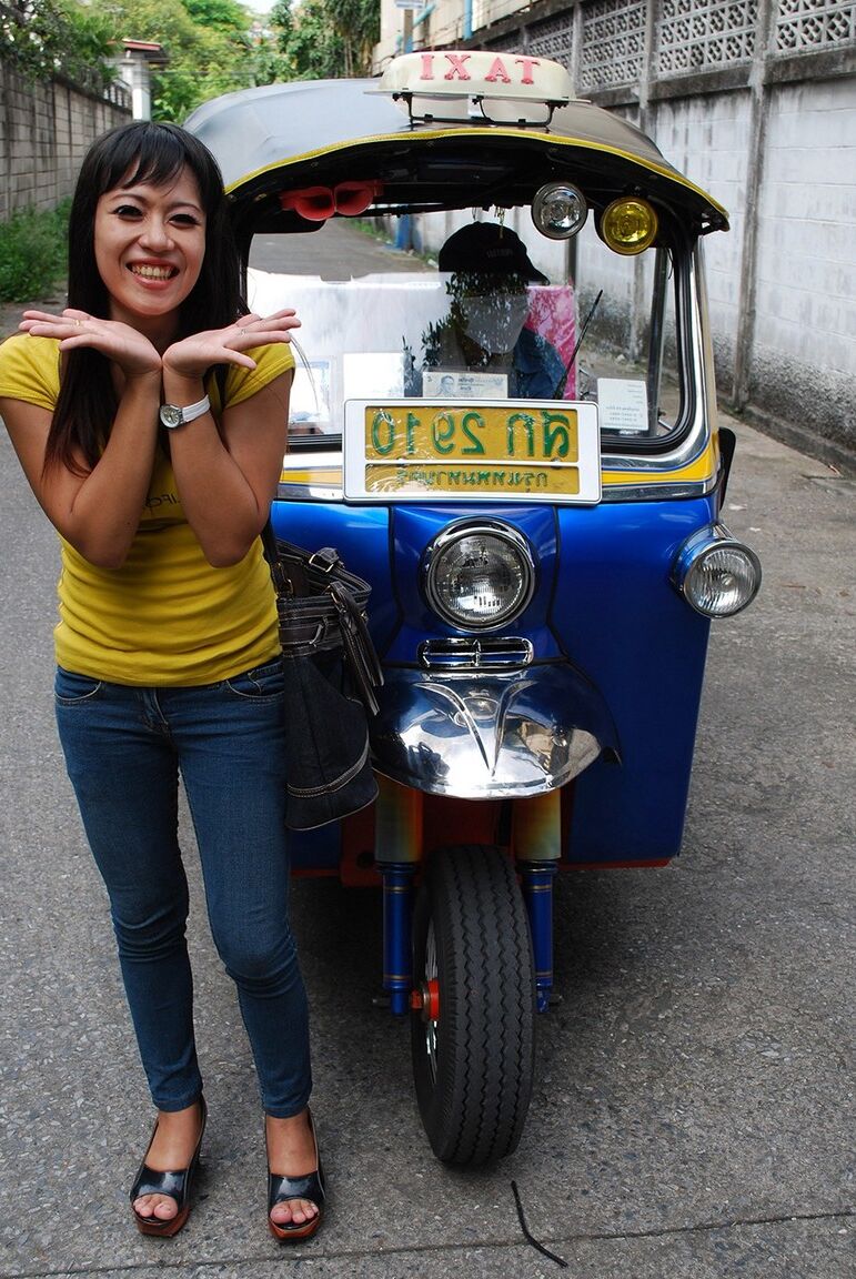 17P Female Tuk Tuk driver and a Farang ham it up for the camera in a back alley