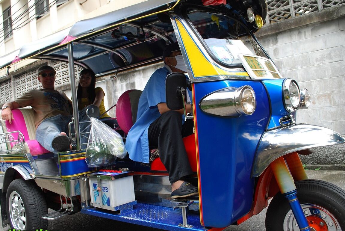 17P Female Tuk Tuk driver and a Farang ham it up for the camera in a back alley