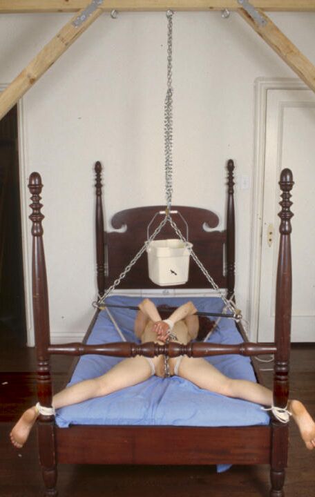 21P Tied up redhead Lyssa gets humiliated and punished on a torture bed
