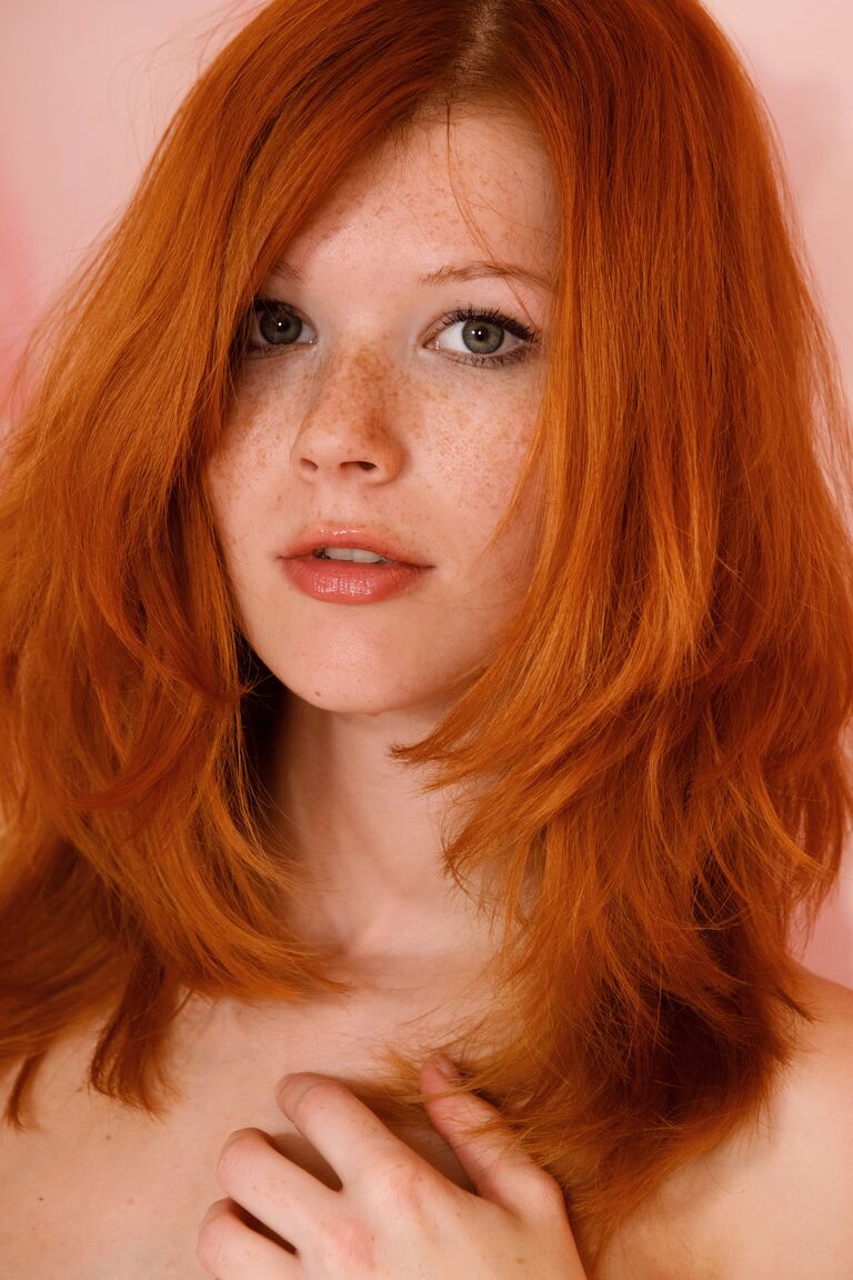 21P Hot redhead Mia Sollis exposes her attractive slim body and poses on a bed