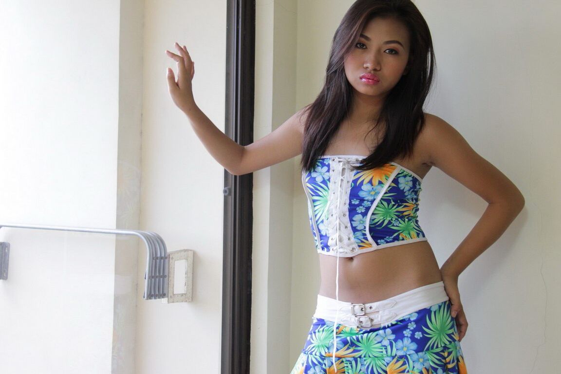 12P Young Asian girl removes clothes and white underwear in front of a window