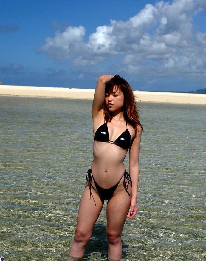 16P Linda adolescente asiática gosta de modelar seus minúsculos biquínis sensuais à beira-mar