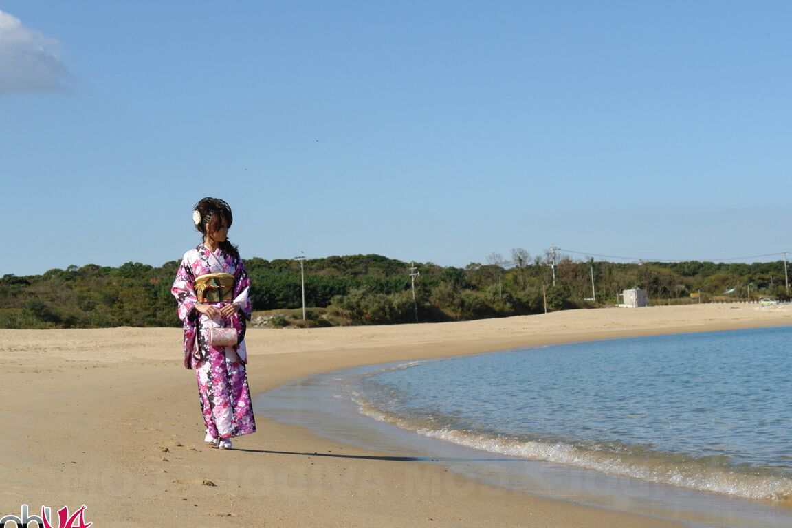 15P Asian model Chiaki strolls along the beach and surrounding area in a kimono