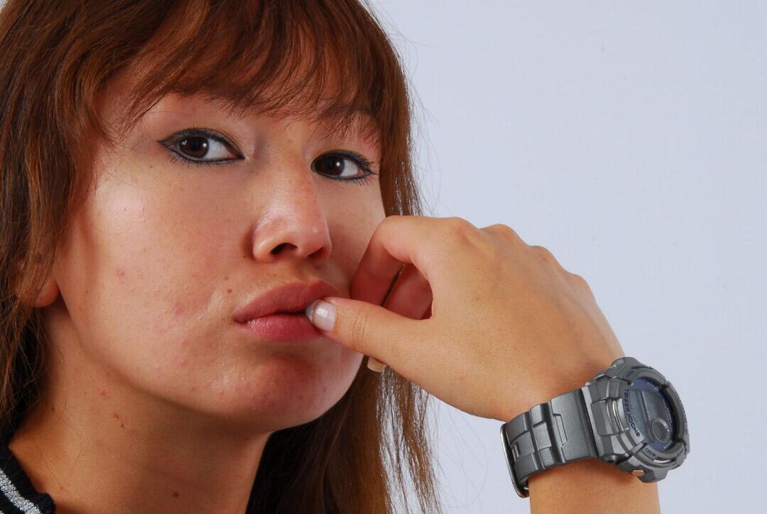 16P Asian redhead Evita models a grey G-Shock watch while fully clothed