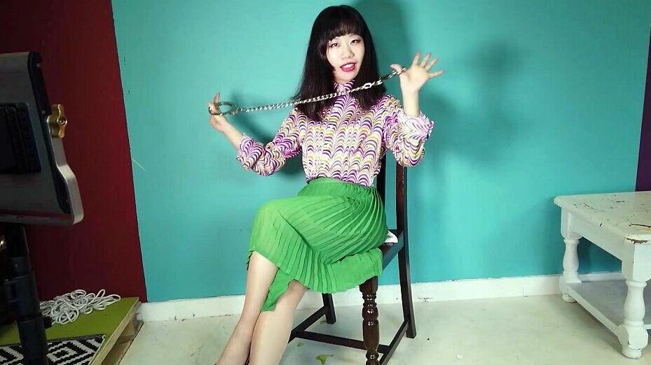 16P Close Asian chick removes ankle cuffs after being chained to a chair