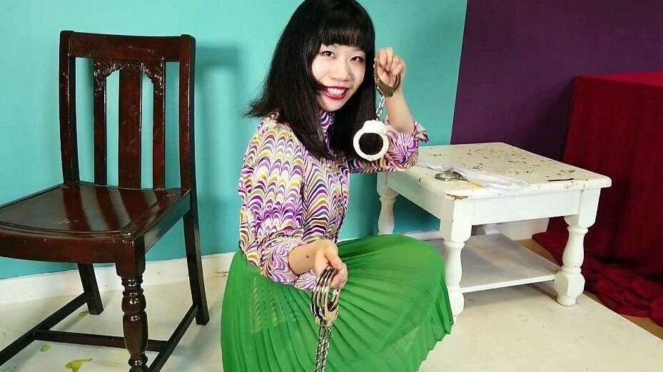 16P Close Asian chick removes ankle cuffs after being chained to a chair