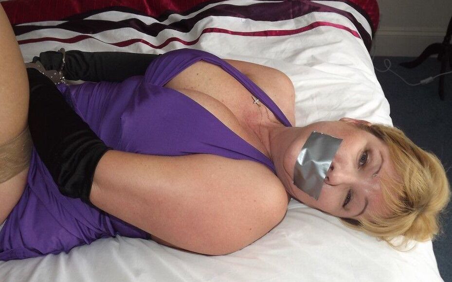 14P Busty older blonde is left tied up and gagged in numerous outfits