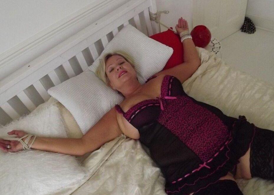 14P Busty older blonde is left tied up and gagged in numerous outfits