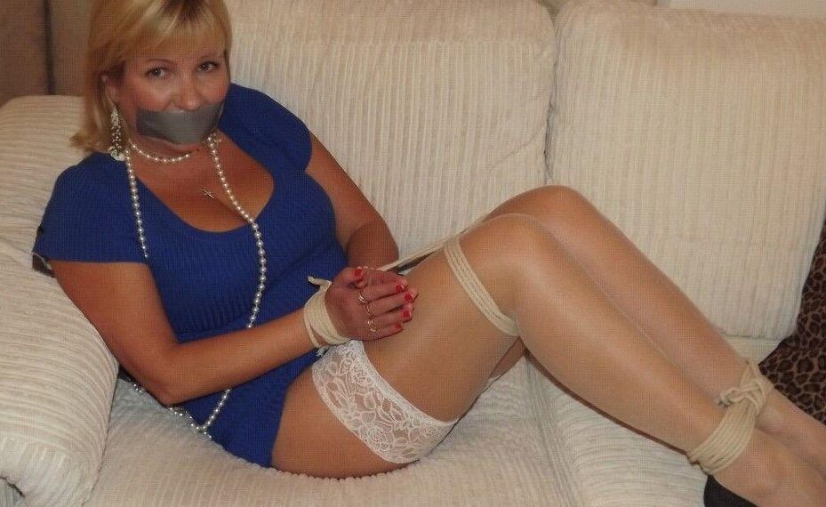 14P Busty older blonde is left tied up and gagged in numerous outfits