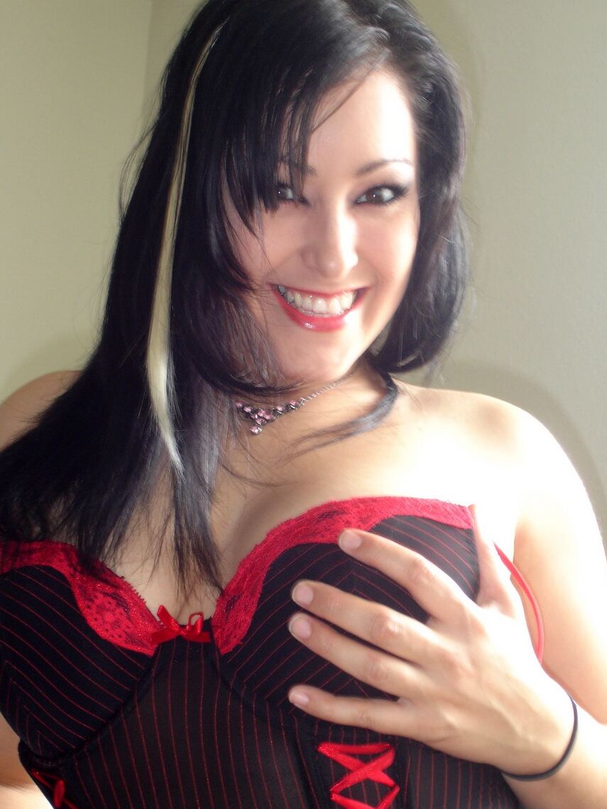 12P Kitty squeezes her huge tits together in her tight corset