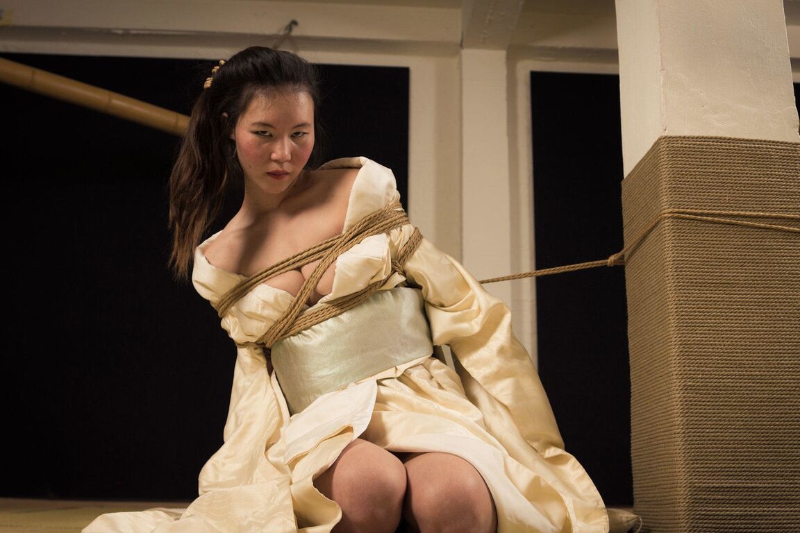 16P Asian model Flawless Meow is restrained with rope during a Shibari shoot