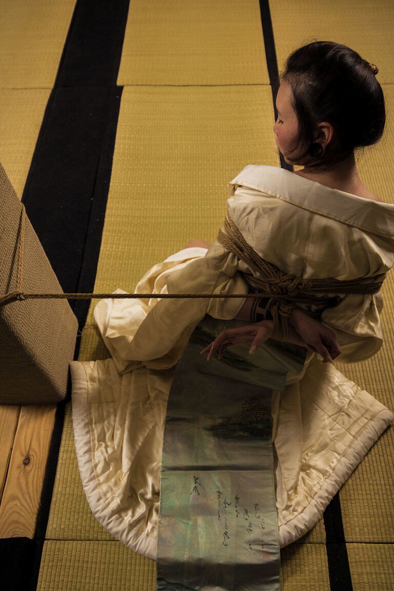 16P Asian model Flawless Meow is restrained with rope during a Shibari shoot