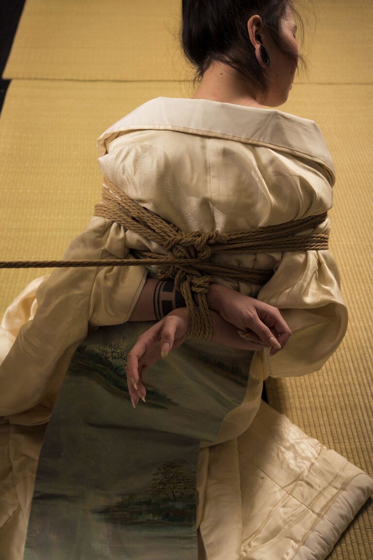 16P Asian model Flawless Meow is restrained with rope during a Shibari shoot