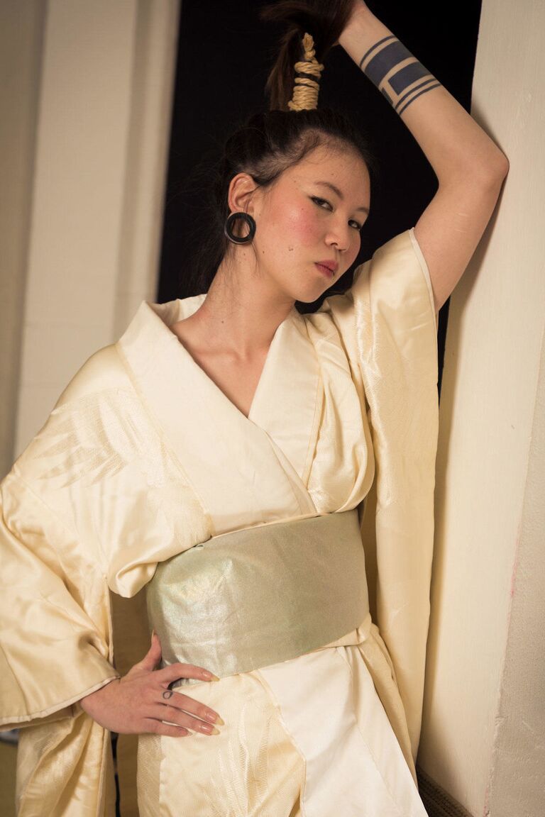 16P Asian model Flawless Meow is restrained with rope during a Shibari shoot