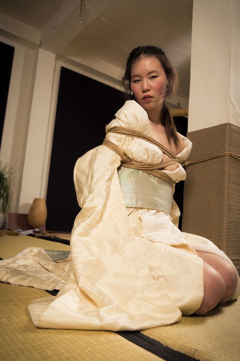 16P Asian model Flawless Meow is restrained with rope during a Shibari shoot