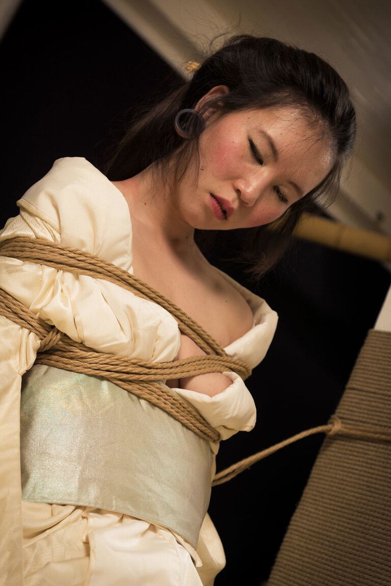 16P Asian model Flawless Meow is restrained with rope during a Shibari shoot