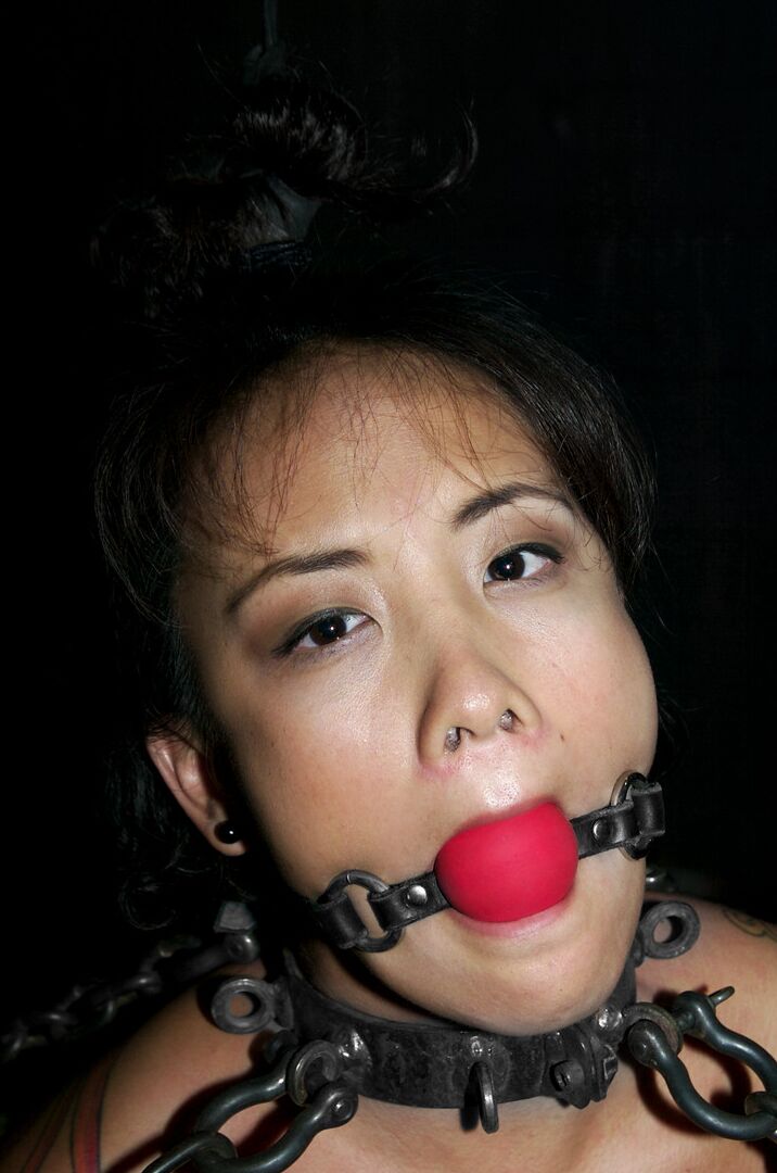 21P Asian babe Jandi Lin gets chained and abused by a kinky dom in bondage action