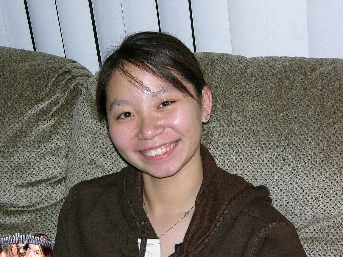 17P Barely legal Asian girl wears nothing more than a smile while showing her twat