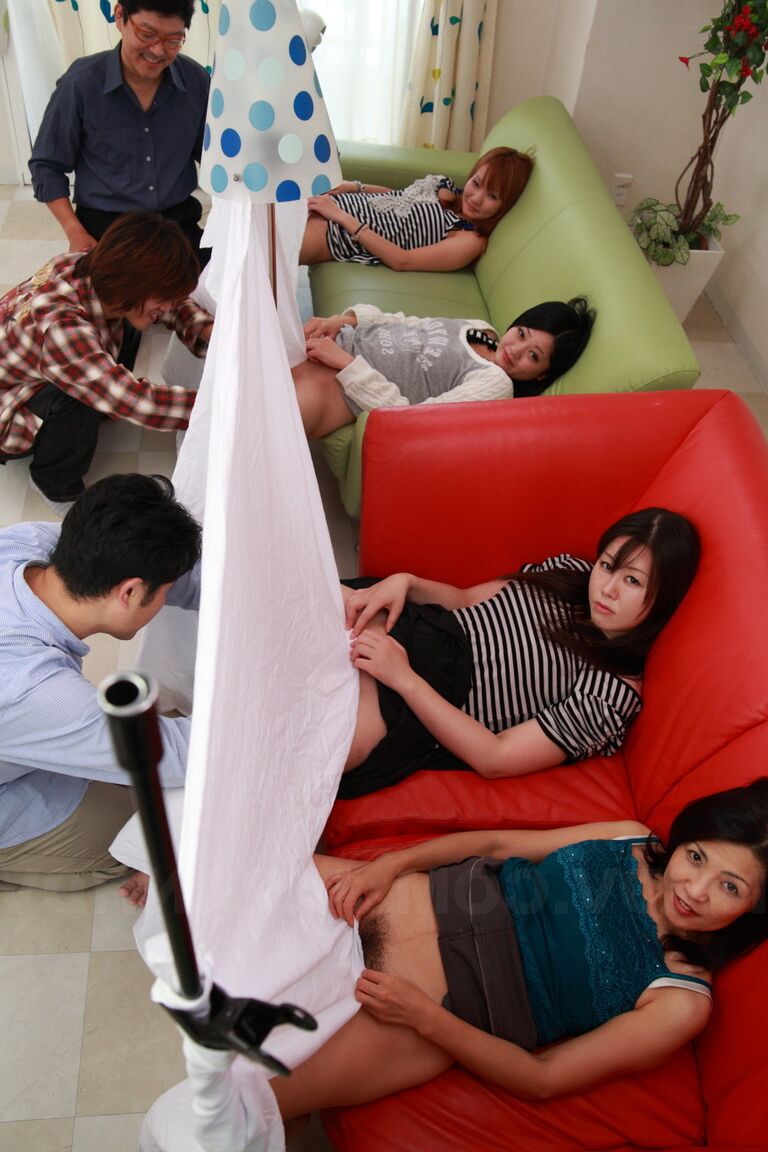 15P Mature Japanese woman fingers her hairy pussy in kinky gloryhole style orgy