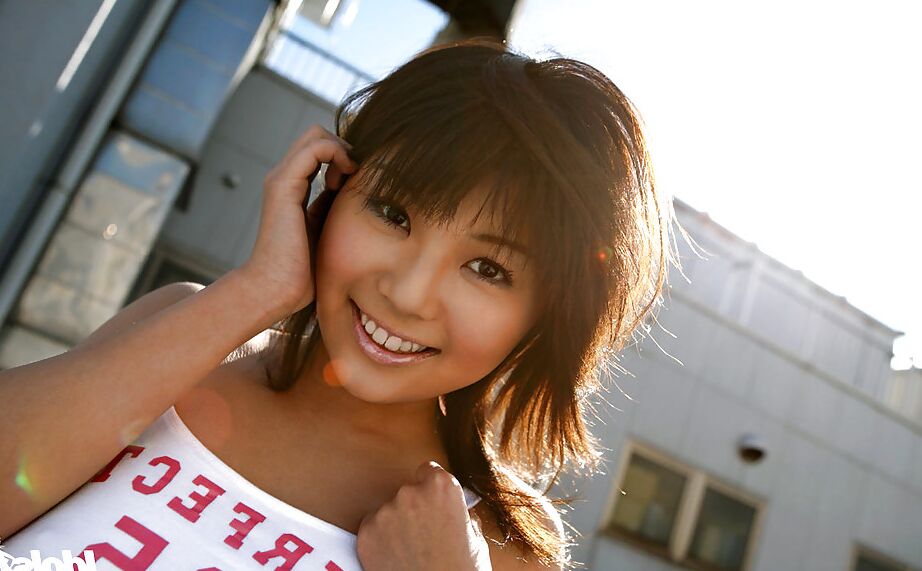 12P Seductive asian babe Azumi Harusaki posing in pink shorts and tiny top