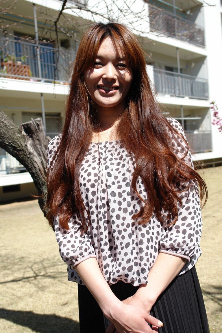 15P Japanese MILF Hitomi Kano wears a nice smile while modeling non nude