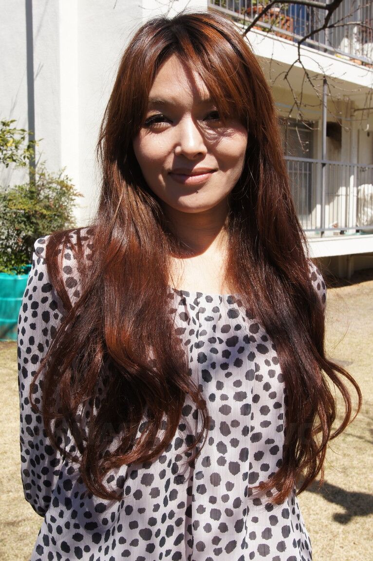 15P Japanese MILF Hitomi Kano wears a nice smile while modeling non nude