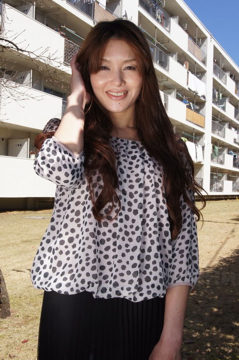 15P Japanese MILF Hitomi Kano wears a nice smile while modeling non nude