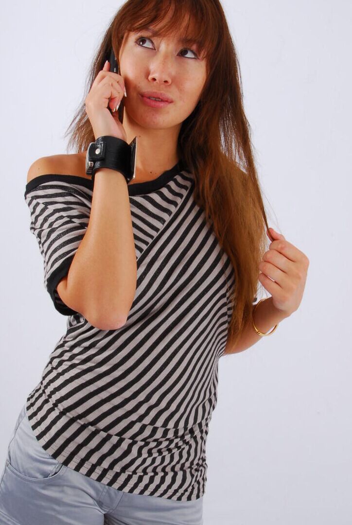 16P Asian redhead Evita glances at her huge Frilis watch while fully clothed