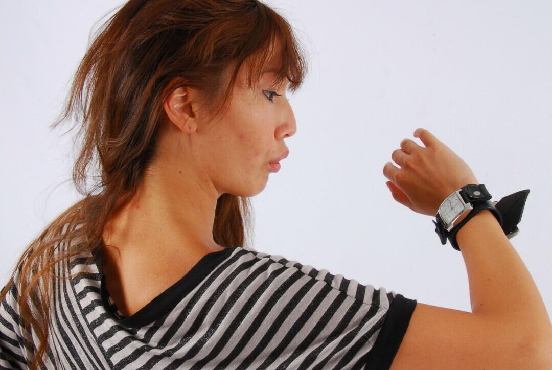 16P Asian redhead Evita glances at her huge Frilis watch while fully clothed