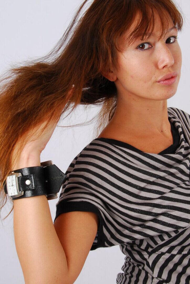 16P Asian redhead Evita glances at her huge Frilis watch while fully clothed