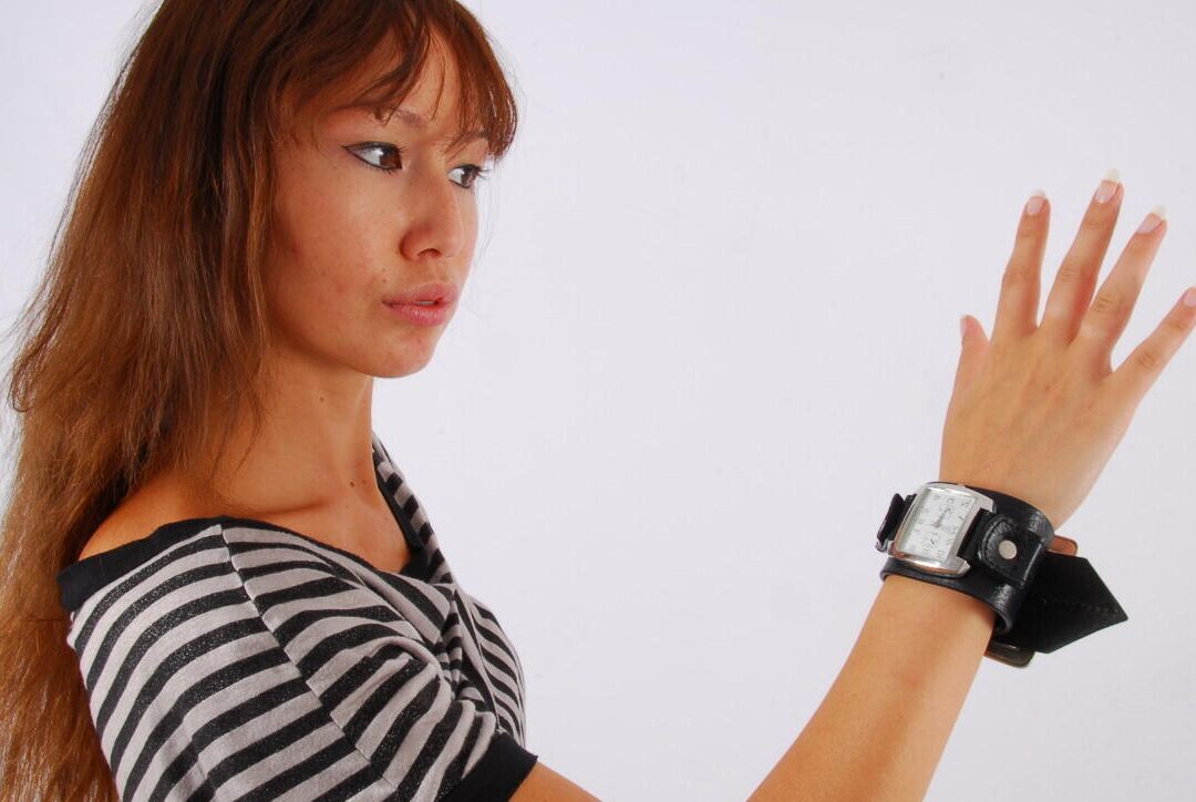 16P Asian redhead Evita glances at her huge Frilis watch while fully clothed