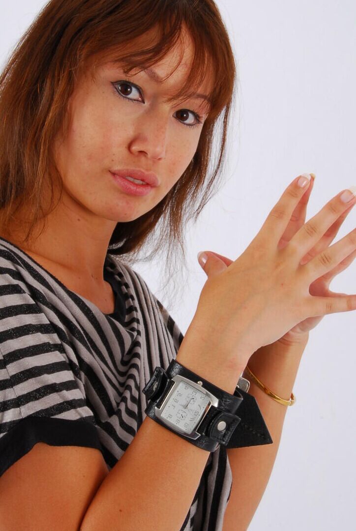 16P Asian redhead Evita glances at her huge Frilis watch while fully clothed
