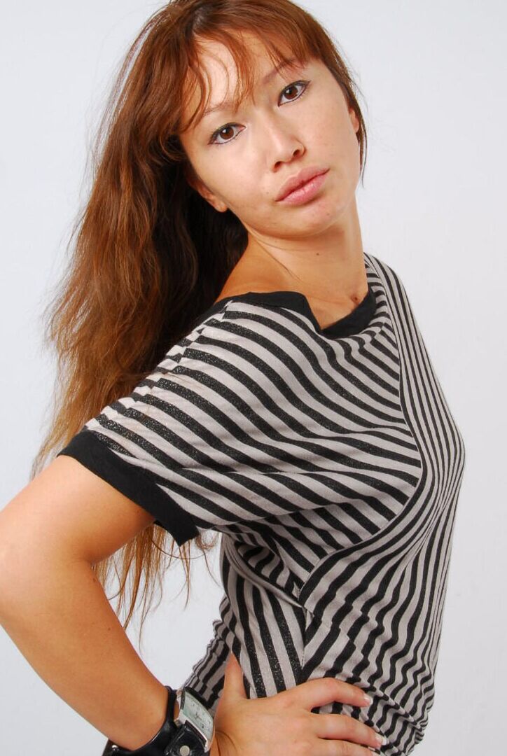 16P Asian redhead Evita glances at her huge Frilis watch while fully clothed